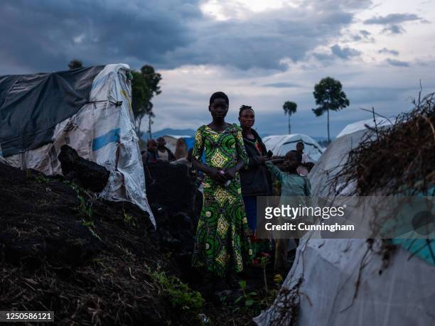 Displaced family stand outside their shelter in Bulengo displacement camp, April 02, 2023 in Goma, Democratic Republic of Congo. M23 rebels have...