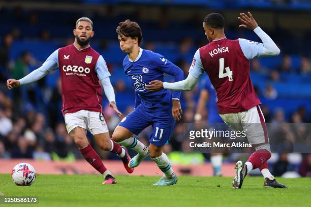 Joao Felix of Chelsea in action with Douglas Luiz and Ezri Konsa of Aston Villa during the Premier League match between Chelsea FC and Aston Villa at...
