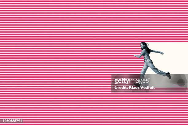 smiling woman running on pink striped pattern - composizione orizzontale foto e immagini stock