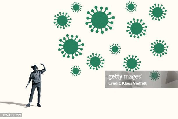 woman shielding eyes by large green coronavirus - bacteria cultures stock pictures, royalty-free photos & images