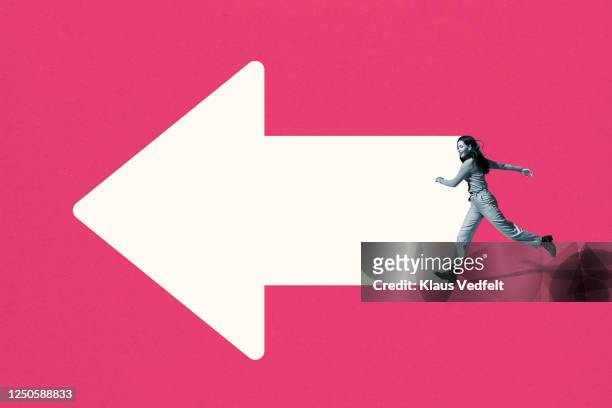 happy young woman running on white arrow - determinazione foto e immagini stock