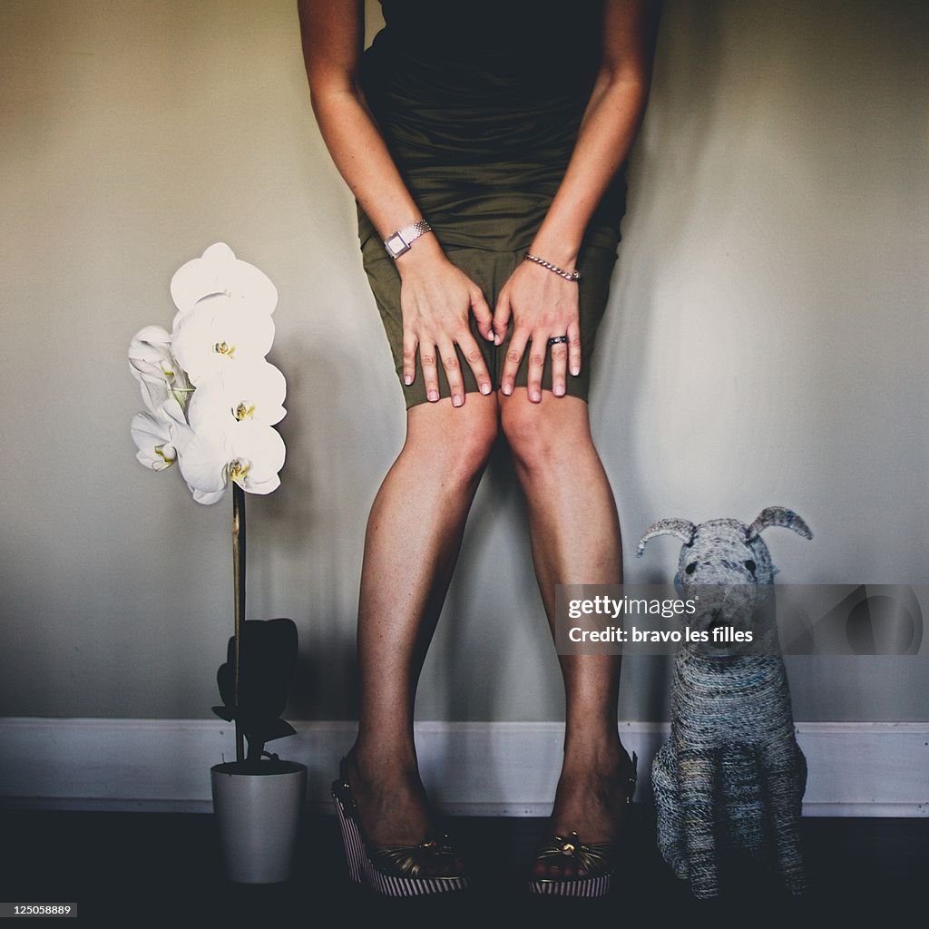 Woman in dress with white orchid and puppet