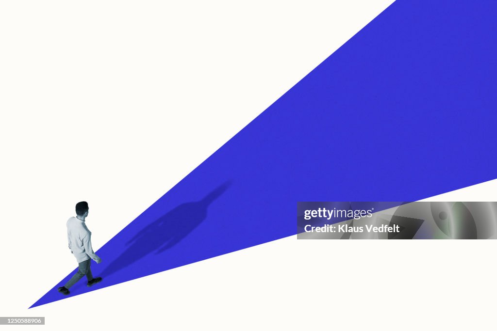 High angle view of young man walking on blue ramp