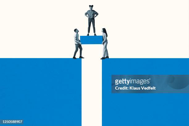 friends carrying block while woman standing on it - trust stock pictures, royalty-free photos & images