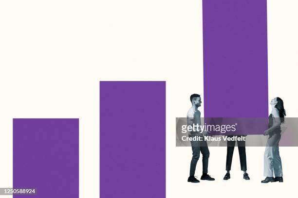 young friends carrying large purple bar graph - part of a series foto e immagini stock