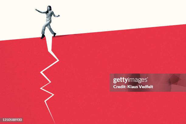 woman walking stealthily on broken red footpath - riesgo fotografías e imágenes de stock