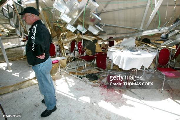 An Israeli inspects the damage inside Park Hotel in Netanya 28 March 2002, following a suicide attack late last night that killed 20 people plus the...