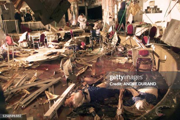 An Israeli police sapper inspects a hotel restaurant in the northern Israeli town of Netanya 27 March 2002 following a suicide bombing that killed at...