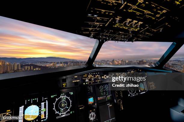 frontal view of the airplane cockpit, see the sunset of the city - dashboard fotografías e imágenes de stock