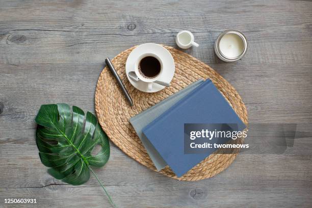 stylised flat lay relaxation reading time with coffee table top still life. - mesa de café - fotografias e filmes do acervo