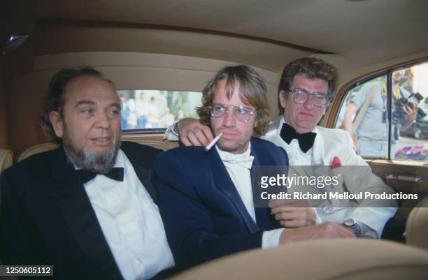 Le réalisateur Marco Ferreri , l’acteur Christophe Lambert et le chanteur-acteur Eddy Mitchell , en voiture au Festival de Cannes.