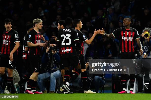 Milan's Portuguese forward Rafael Leao celebrates with his teammates after scoring his side's third goal during the Italian Serie A football match...