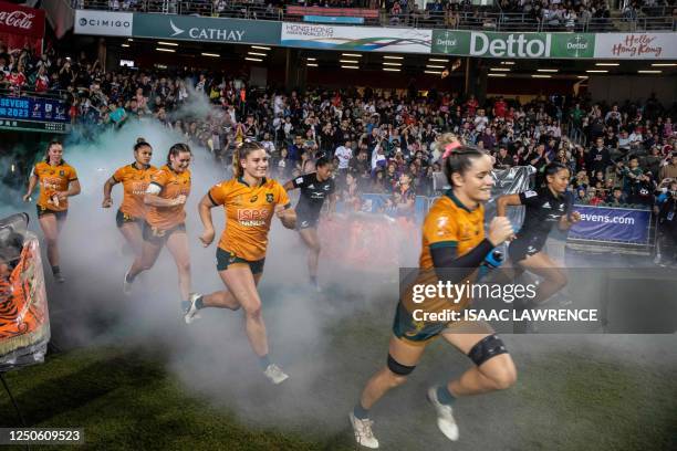 New Zealand and Australia run onto the field before the final on the third day of the Hong Kong Sevens rugby tournament on April 2, 2023.