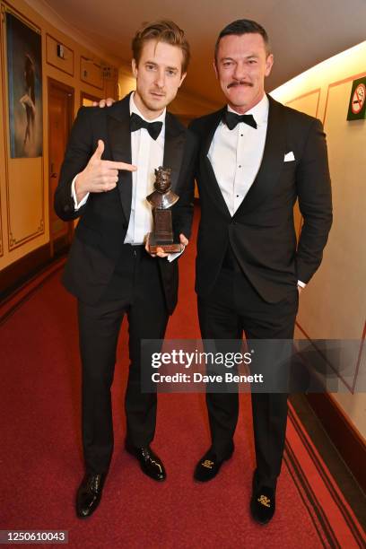 Arthur Darvill, winner of the Best Actor in a Musical award for "Rodgers & Hammerstein's Oklahoma!" and Luke Evans pose backstage at The Olivier...