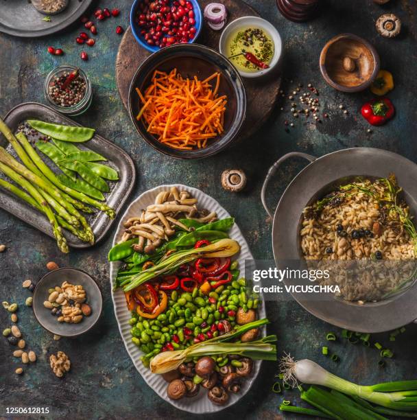 tasty colorful vegan grazing plate with various roasted vegetables and mushrooms served on dark rustic kitchen table with rice - veganist stockfoto's en -beelden