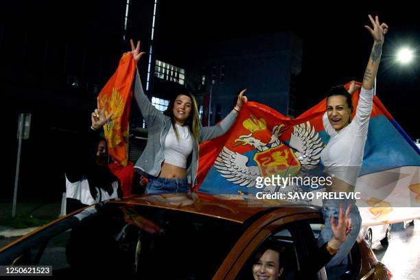Supporters of the newly-elected president of Montenegro, Jakov Milatovic wave the Serbian flag after the second round of the presidential election in...