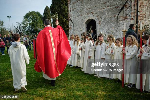 Priest is seen blessing people during the celebration. Palm Sunday, also called Passion Sunday, is the first day of the Holy Week, is celebrated the...
