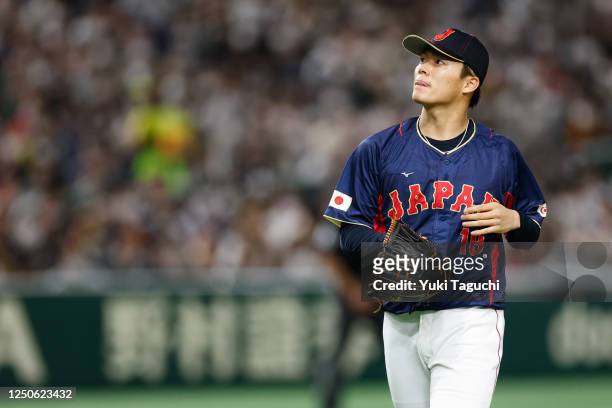 Yoshinobu Yamamoto of Team Japan looks on while pitching during Game 8 of Pool B between Team Japan and Team Australia at Tokyo Dome on Sunday, March...