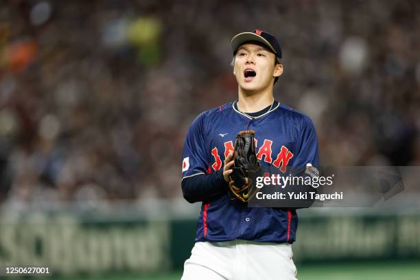 Yoshinobu Yamamoto of Team Japan reacts while pitching during Game 8 of Pool B between Team Japan and Team Australia at Tokyo Dome on Sunday, March...