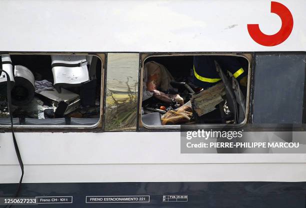 Rescue workers try to free bodies from the train after it exploded at the Atocha train station in Madrid 11 March 2004. At least 173 people were...