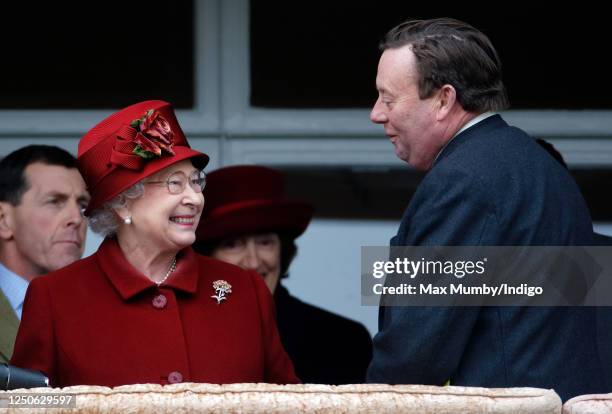 Queen Elizabeth II accompanied by trainer Nicky Henderson watches her horse 'Barbers Shop' run in the Gold Cup on day 4 'Gold Cup Day' of the...