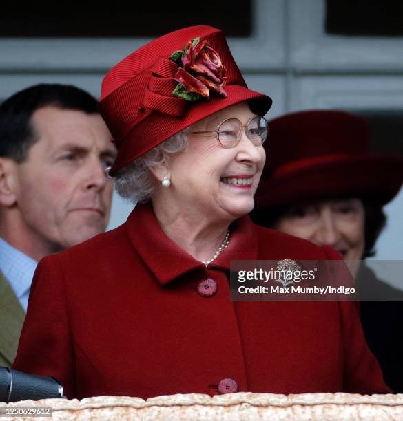 Queen Elizabeth II reacts as she watches her horse 'Barbers Shop' run in the Gold Cup on day 4 'Gold Cup Day' of the Cheltenham Festival at...