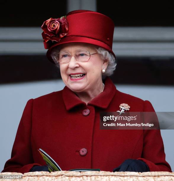 Queen Elizabeth II watches her horse 'Barbers Shop' run in the Gold Cup on day 4 'Gold Cup Day' of the Cheltenham Festival at Cheltenham Racecourse...