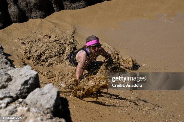 Competitors take part in "Tough Mudder" at the Glen Helen Raceway in San Bernardino, California, United States on April 2, 2023. Tough Mudder is an...