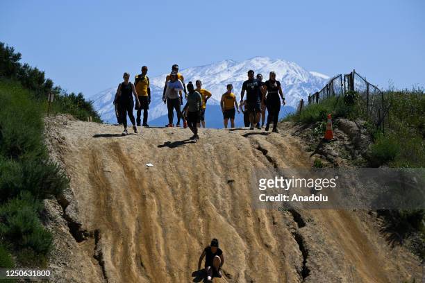 Competitors take part in "Tough Mudder" at the Glen Helen Raceway in San Bernardino, California, United States on April 2, 2023. Tough Mudder is an...