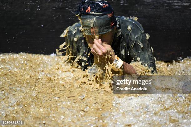 Competitors take part in "Tough Mudder" at the Glen Helen Raceway in San Bernardino, California, United States on April 2, 2023. Tough Mudder is an...