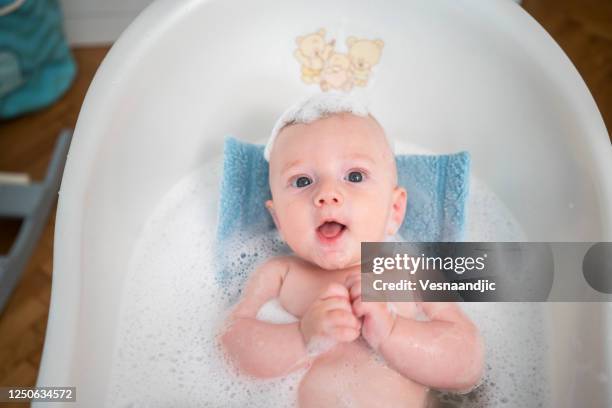 baby bathing - 4 months stock pictures, royalty-free photos & images