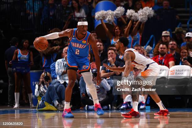 Shai Gilgeous-Alexander of the Oklahoma City Thunder handles the ball during the game against the Phoenix Suns on April 2, 2023 at Paycom Arena in...