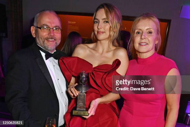 Jodie Comer poses with parents James Comer and Donna Comer at The Olivier Awards 2023 after party at the Natural History Museum on April 2, 2023 in...