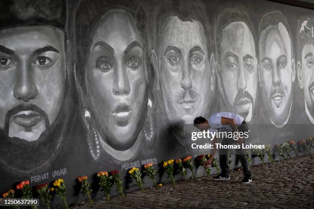 Cetin Gueltekin, the brother of Goekhan Gueltekin lays flowers in front of a 27 meter long street art mural to commemorate the nine victims of the...
