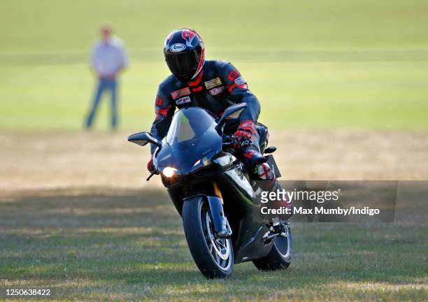 Prince William departs, riding his Ducati 1198S motorbike, after playing in the Westbury Shield charity polo match at Coworth Park Polo Club on July...