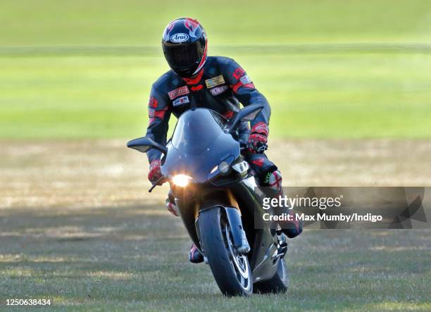 Prince William departs, riding his Ducati 1198S motorbike, after playing in the Westbury Shield charity polo match at Coworth Park Polo Club on July...