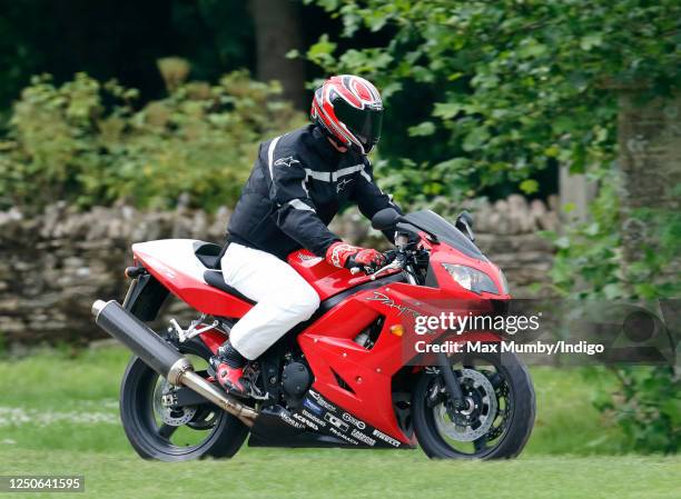 Prince William arrives, riding his Triumph Daytona 600 motorbike, to play in the Burberry Cup polo match at Cirencester Park Polo Club on June 17,...