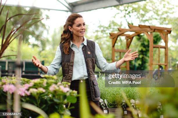 Catherine, Duchess of Cambridge talks to Martin and Jennie Turner, owners of the Fakenham Garden Centre in Norfolk, during her first public...