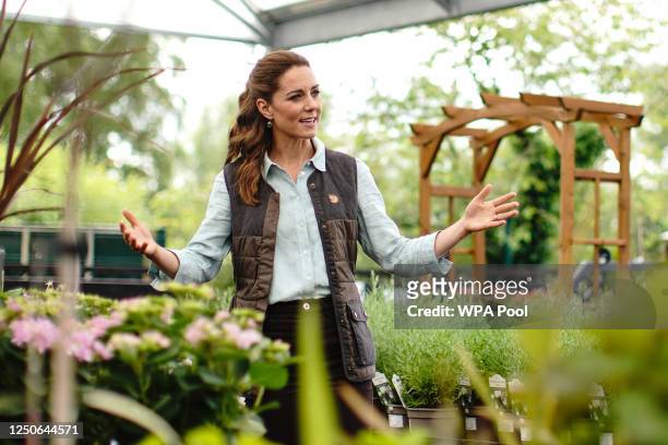 Catherine, Duchess of Cambridge talks to Martin and Jennie Turner, owners of the Fakenham Garden Centre in Norfolk, during her first public...