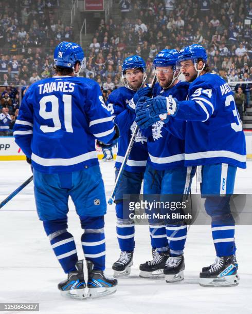 John Tavares of the Toronto Maple Leafs celebrates his goal against the Detroit Red Wings with teammates Calle Jarnkrok, Morgan Rielly and Auston...