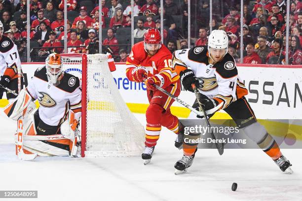 Jonathan Huberdeau of the Calgary Flames battles Cam Fowler of the Anaheim Ducks for the puck during the third period of an NHL game at Scotiabank...