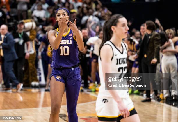 Angel Reese of the LSU Lady Tigers reacts in front of Caitlin Clark of the Iowa Hawkeyes towards the end of the 2023 NCAA Women's Basketball...