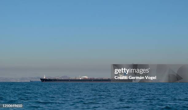 large oil tanker ship smoking sails strait of hormuz, persian gulf, iran - iran oil stock pictures, royalty-free photos & images