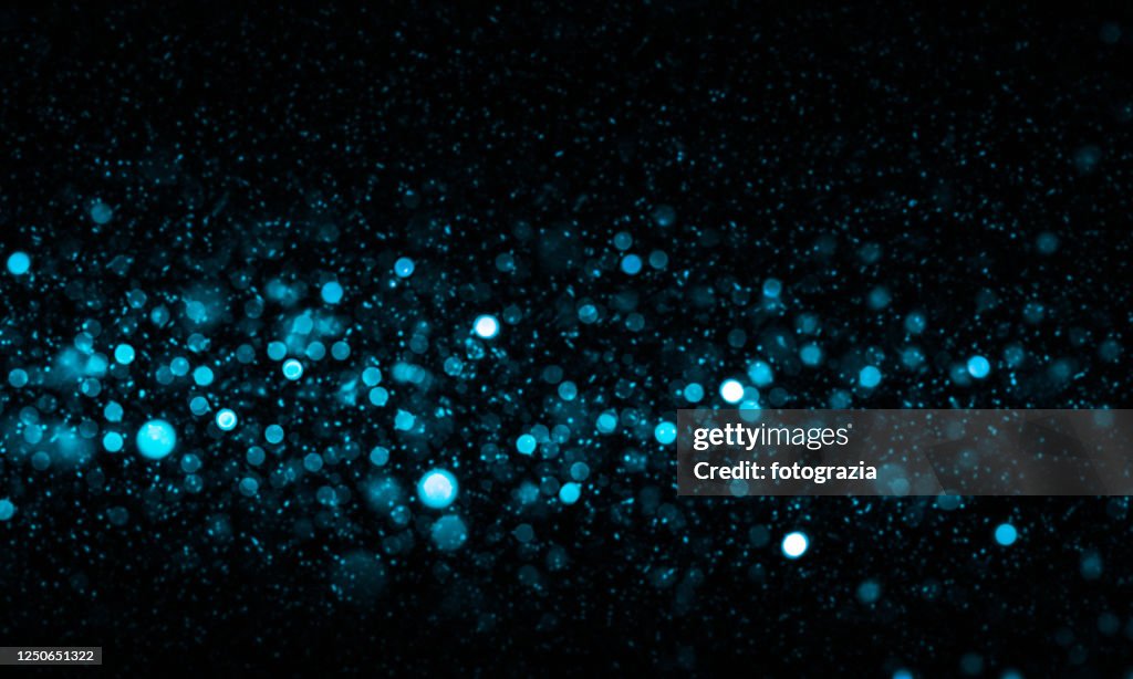 Defocused Lights and Dust Particles over Black Background