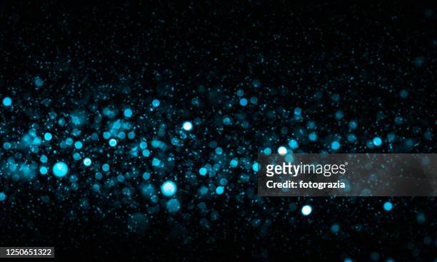 defocused lights and dust particles over black background - glamour stock pictures, royalty-free photos & images