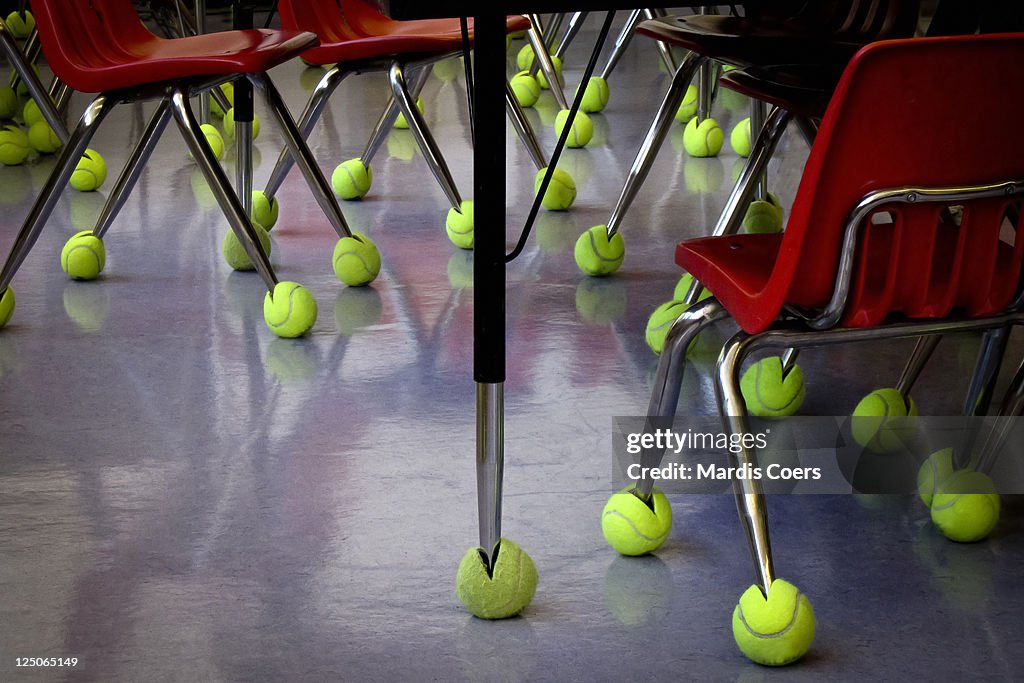 Used tennis balls on classroom chair and desk legs