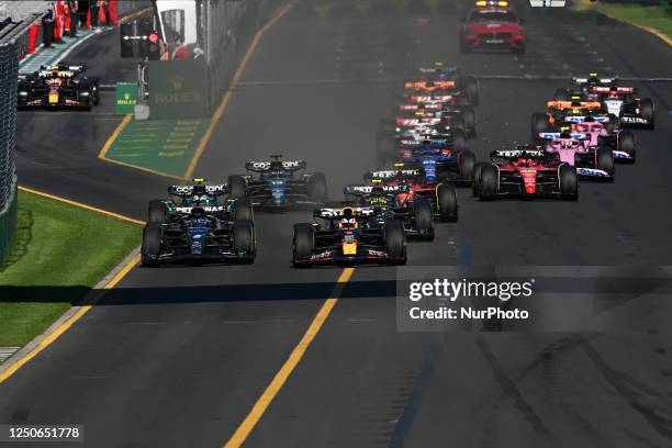 George Russell of the United Kingdom drives the Mercedes alongside Max Verstappen of the Netherlands who drives the Red Bull Racing during the 2023...