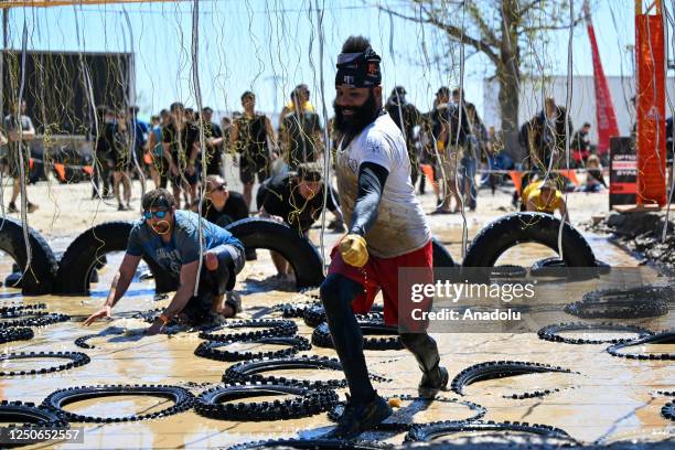 Competitors take part in "Tough Mudder" at the Glen Helen Raceway in San Bernardino, California, United States on April 2, 2023. Tough Mudder is an...