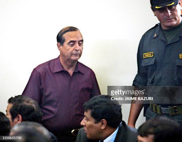 Vladimiro Montesinos , former Peruvian President Alberto Fujimori's right-hand man, arrives at a judiciary courthouse in Lima, 20 January 2004, to...