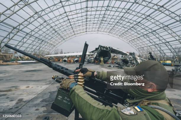 Ukrainian soldier loads ammunition into an M2 Browning machine gun during a handover of mobile anti-aircraft pick-up trucks by Herocar, as part of...